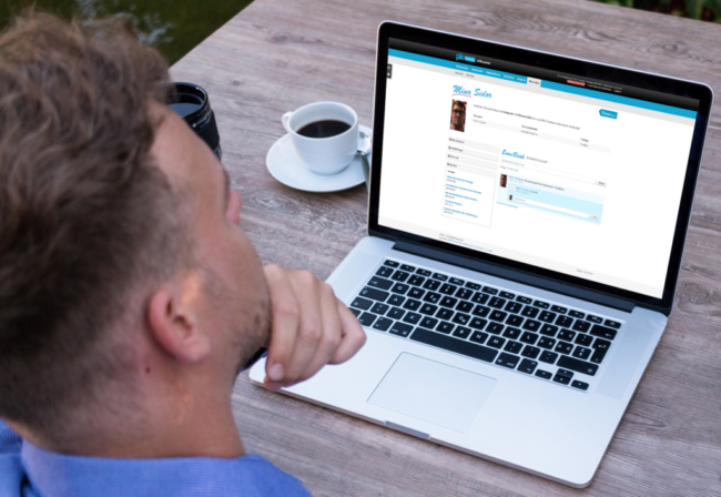 En man som sitter och använder TimeBook, vårt företagsinterna sociala forum.